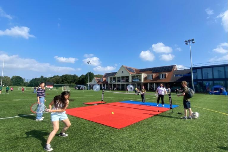 Group of young people playing tennis
