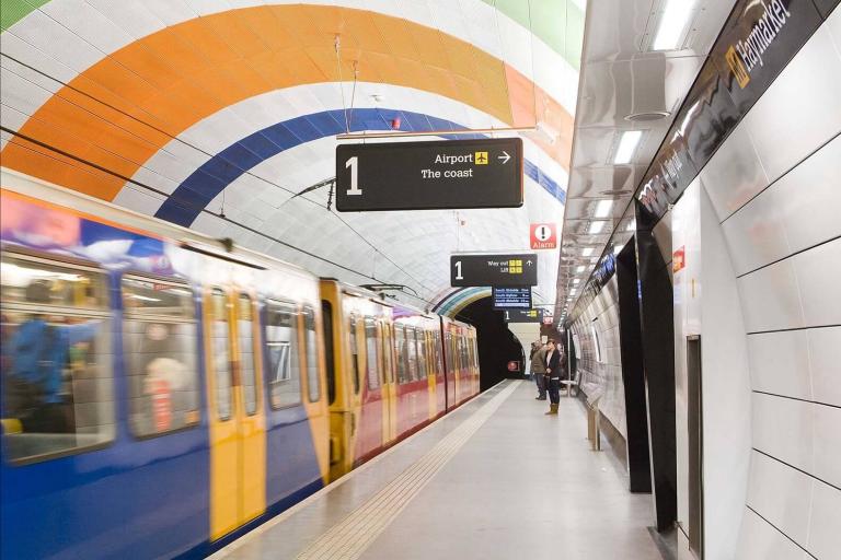 A metro train moving in an underground station
