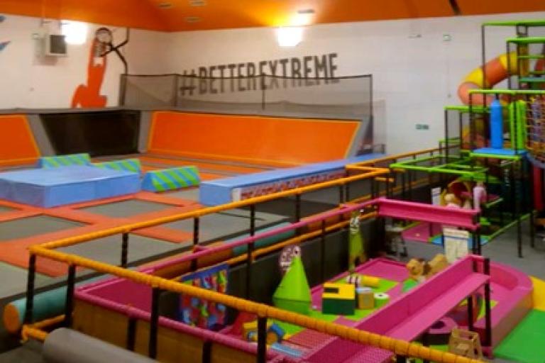 Photo of Newcastle Trampoline Park showing a large space with trampolines and a soft play area 