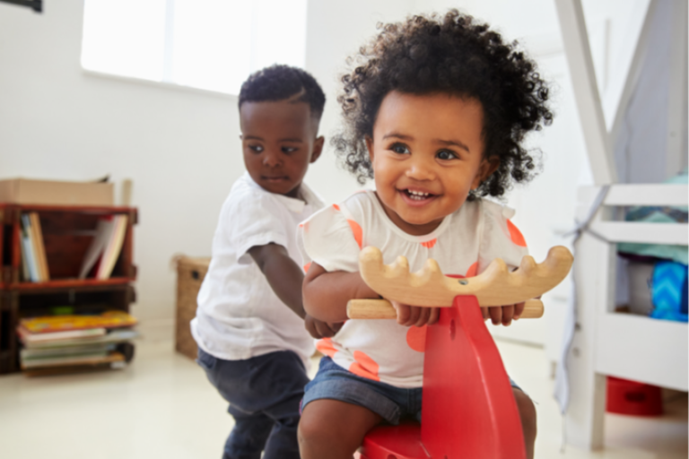 Children playing on a rocking horse