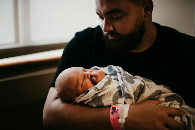 DAD HOLDING BABY IN HOSPITAL