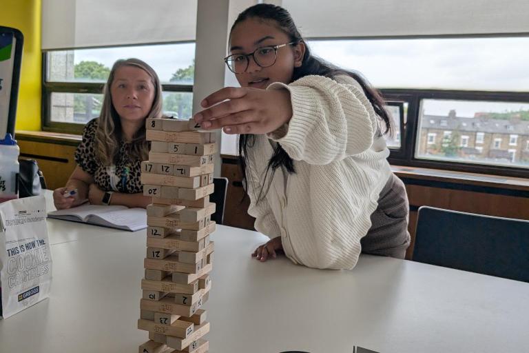 Young person playing jenga 