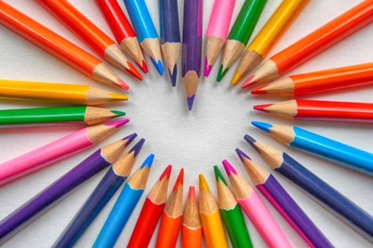 Coloured pencils pointing towards each other to make a heart shape