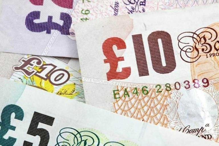 Various British banknotes arranged together.