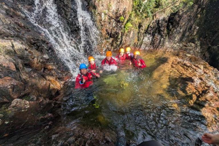Young people in waterfall