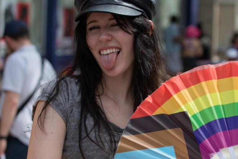 Young person with LGBT fan at pride 