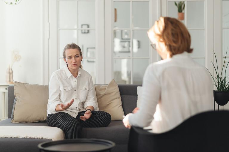 Two ladies sitting in a room facing each other