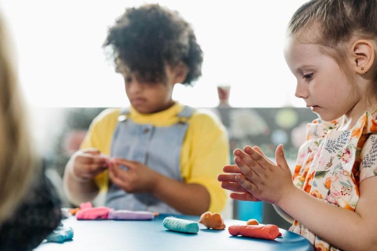 Children sat playing with playdough