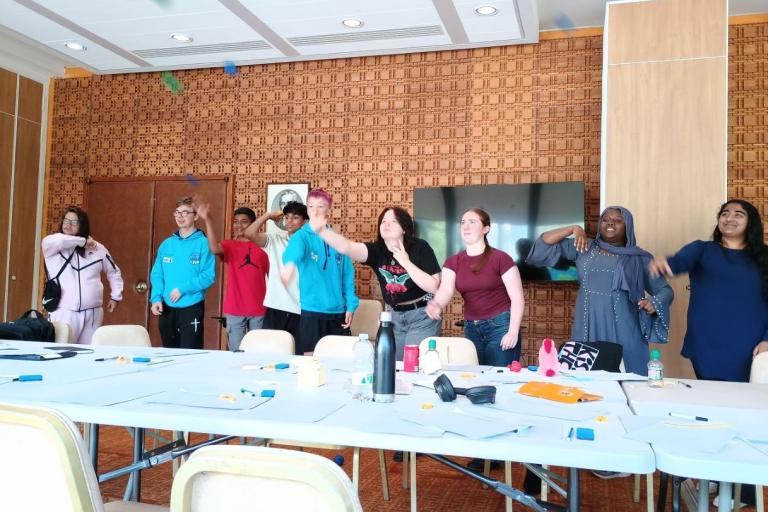 Group of young people playing a throwing game.