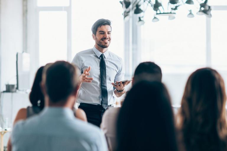 Male trainer standing in front of seated trainees
