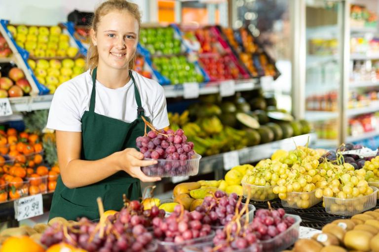 Teenager working in a fruit and vegetable shop