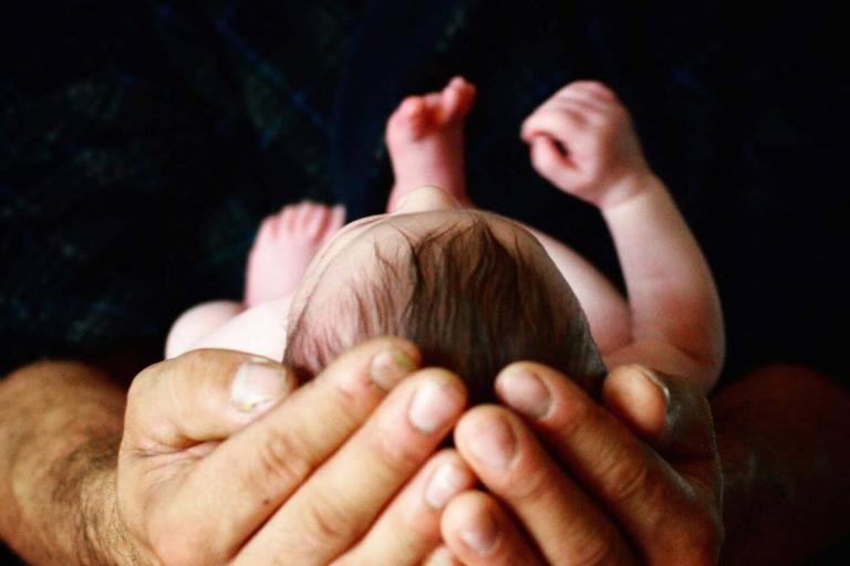 Newborn in dad's hands