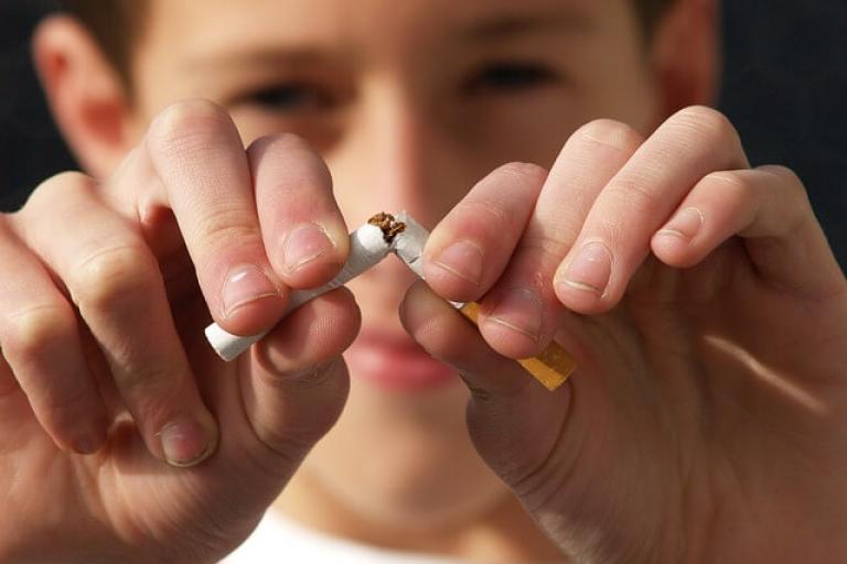young man snapping a cigarette 