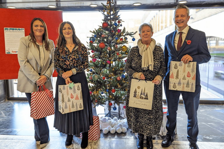 Cath, Cllr Storey, and Cllr Kemp with the gift Christmas tree 