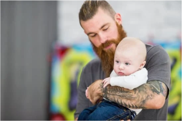 Tattooed dad with young child