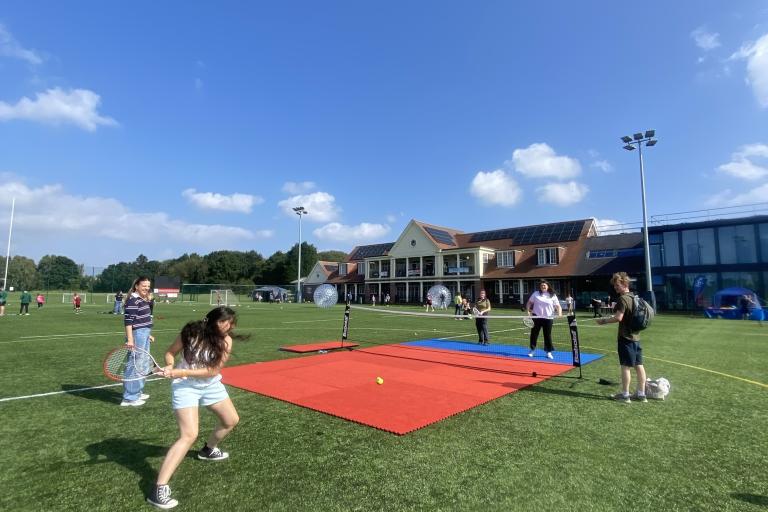 Group of young people playing tennis