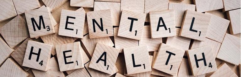 Wooden scrabble letters spelling out the words mental health 