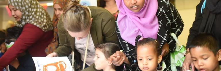 Mother_and_kids_looking_at_books