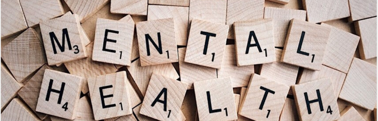 Wooden scrabble letters spelling out the words mental health 